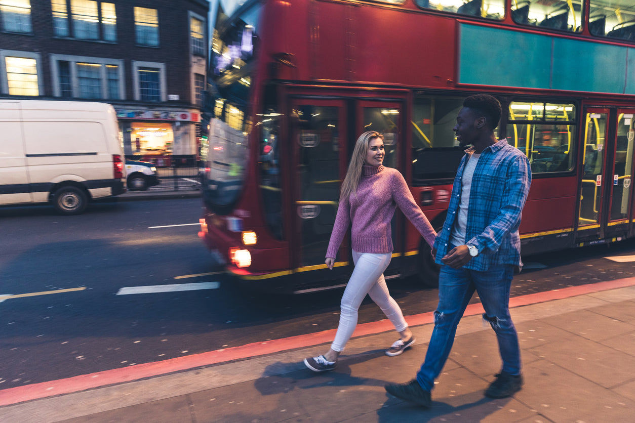 A couple looking for fertility blood tests in London walk along the street hand in hand