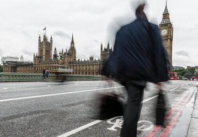 a man walks across london bridge considering a health screen